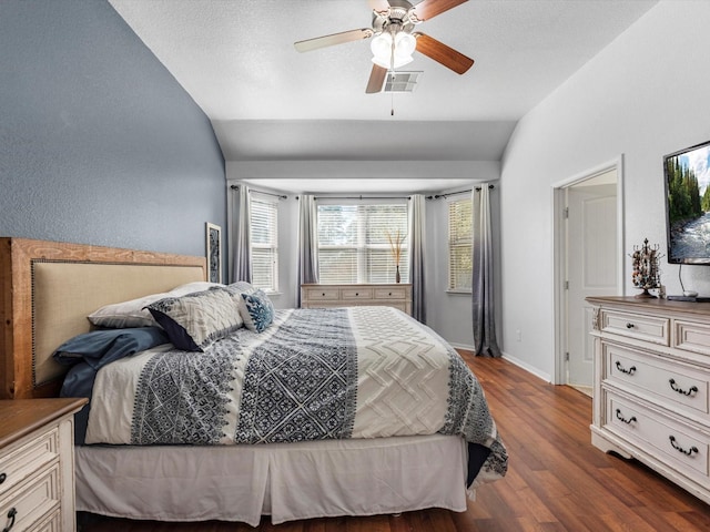 bedroom with ceiling fan, dark hardwood / wood-style floors, and lofted ceiling