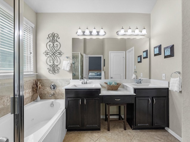 bathroom with a bathtub, vanity, and tile patterned flooring