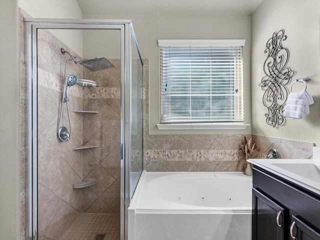 bathroom with vanity and shower with separate bathtub