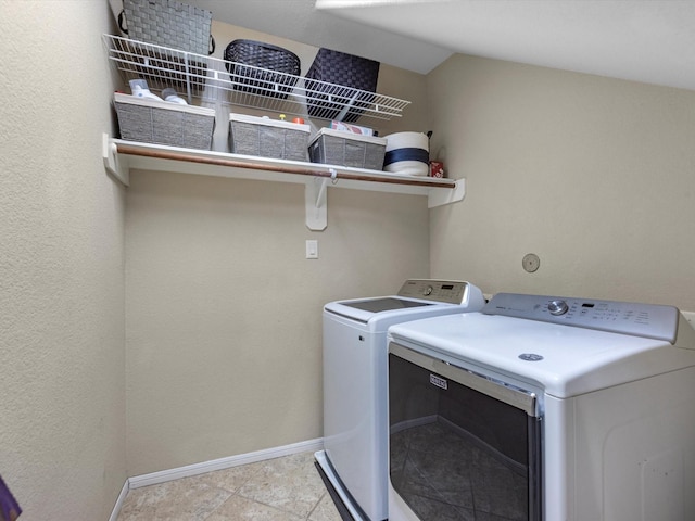 washroom with washing machine and clothes dryer