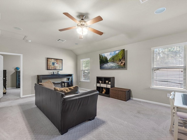 living room with ceiling fan, light carpet, and lofted ceiling