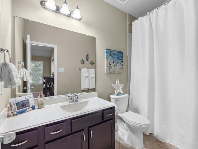 bathroom with tile patterned floors, vanity, and toilet