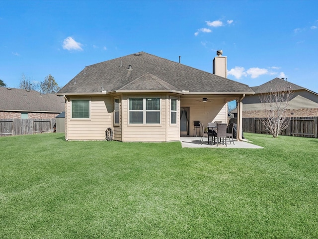 rear view of property featuring a yard, ceiling fan, and a patio area