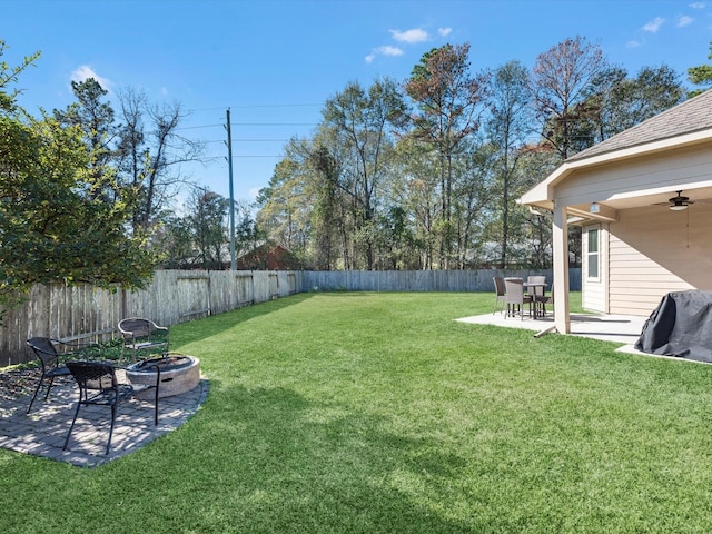 view of yard with ceiling fan and a patio area