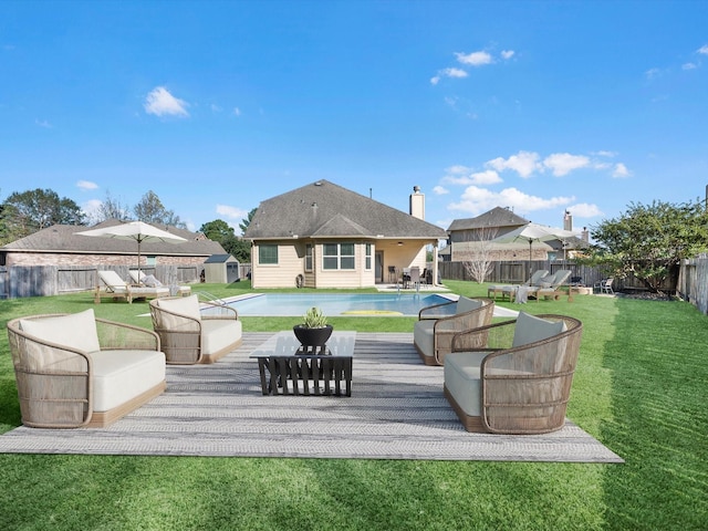 rear view of property with a lawn, an outdoor living space, and a swimming pool