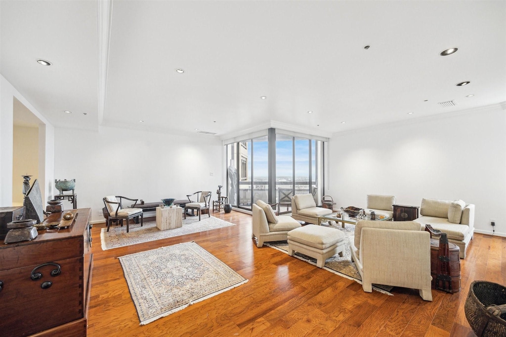 living room with floor to ceiling windows and light wood-type flooring