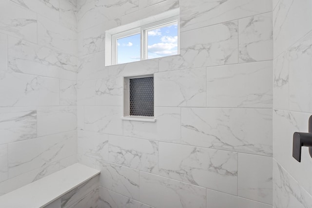 bathroom with tiled shower