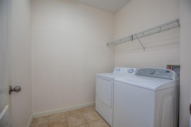 laundry room with light tile patterned flooring and washer and dryer