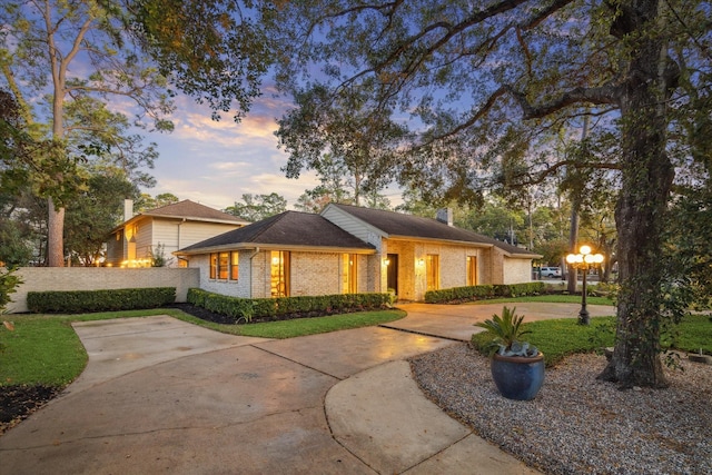 ranch-style home with a yard