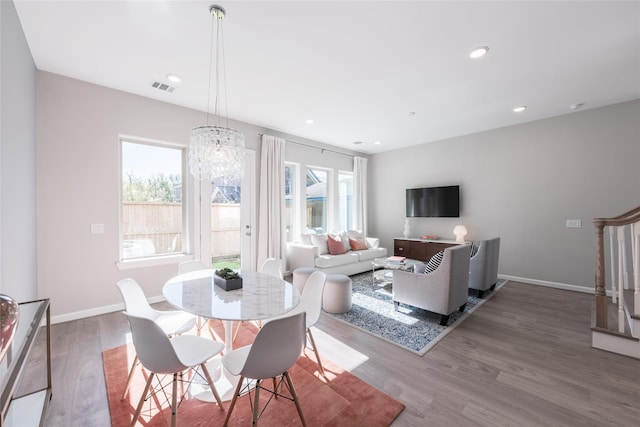 dining room featuring hardwood / wood-style flooring and an inviting chandelier