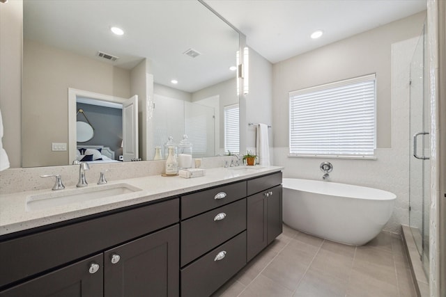 bathroom with separate shower and tub, tile patterned floors, and vanity