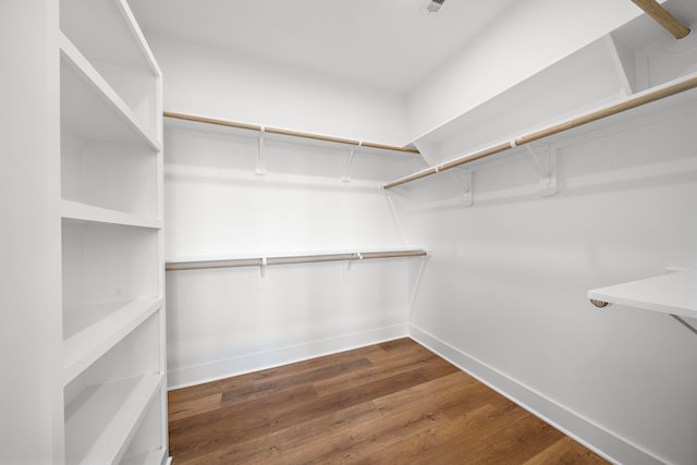 spacious closet with dark hardwood / wood-style floors