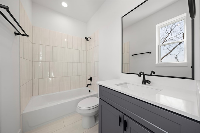 full bathroom featuring tiled shower / bath, vanity, and toilet