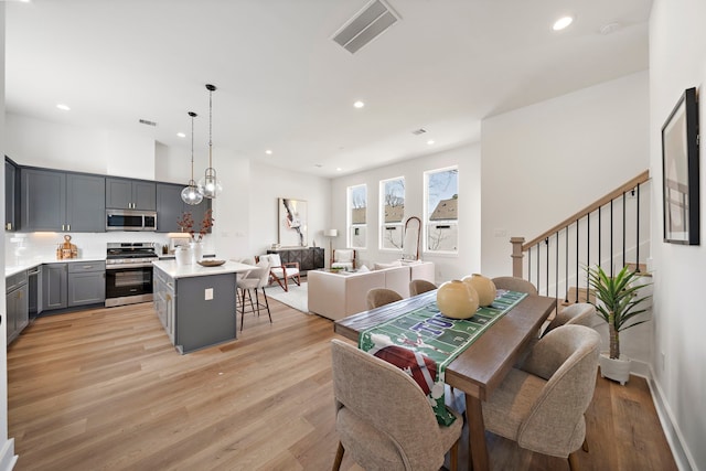 dining area with a notable chandelier and light wood-type flooring