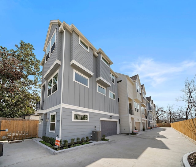 exterior space with a garage and central AC unit