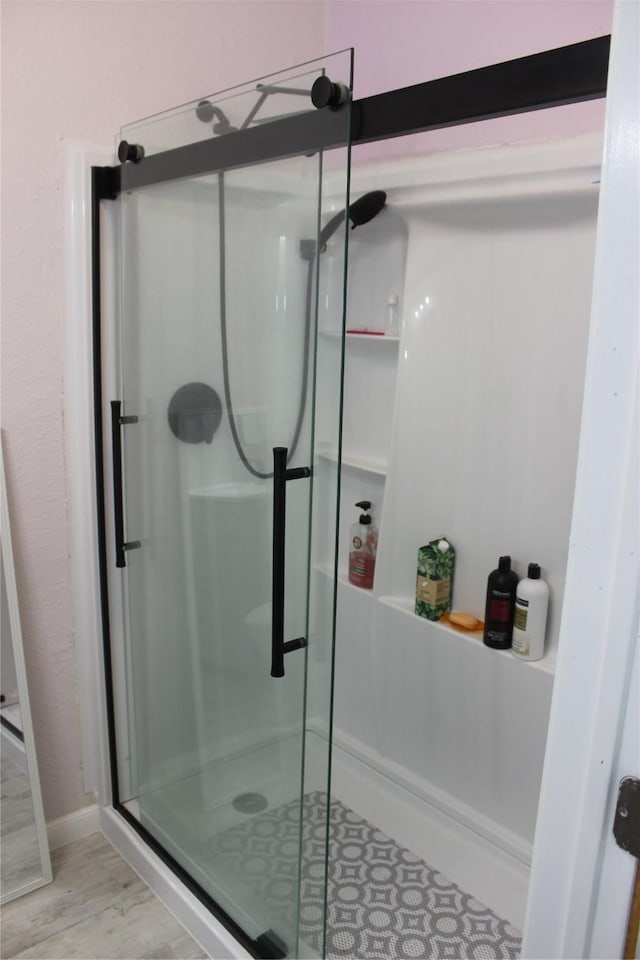 bathroom featuring a shower with shower door