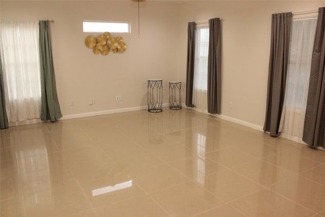 empty room with plenty of natural light and light tile patterned flooring