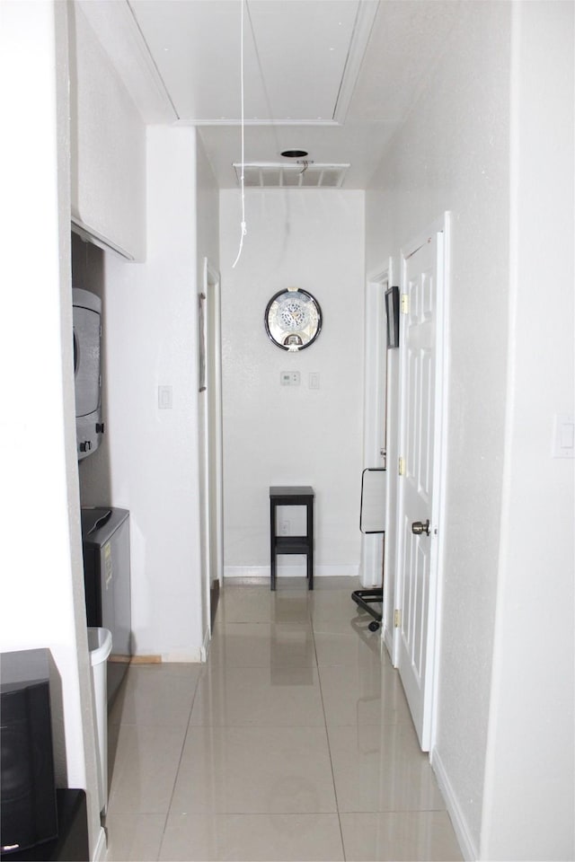 hall featuring light tile patterned floors and washer / clothes dryer