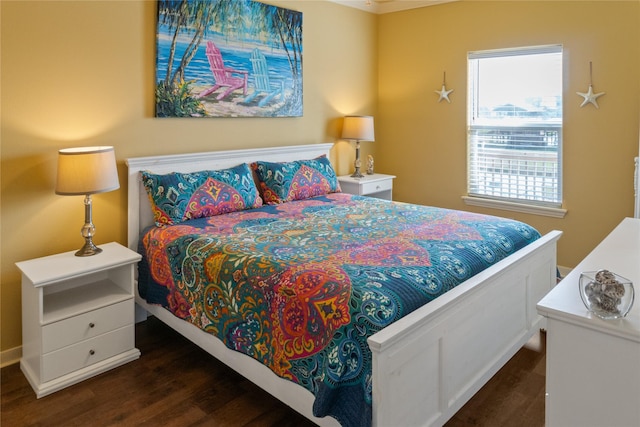 bedroom with dark hardwood / wood-style flooring