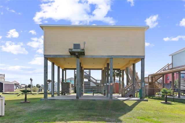 rear view of house featuring a yard