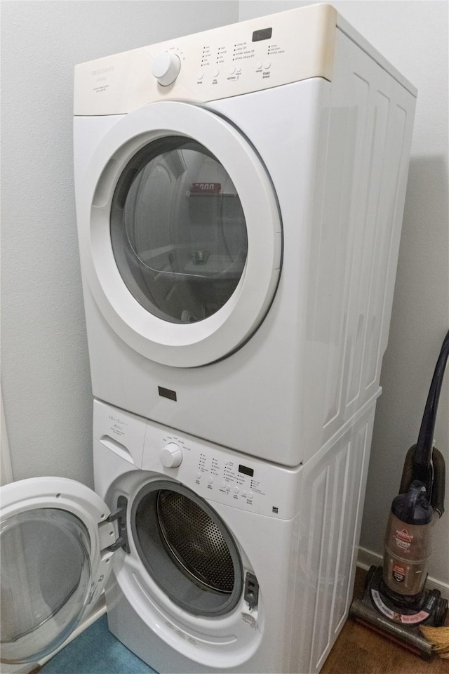 laundry area featuring stacked washing maching and dryer