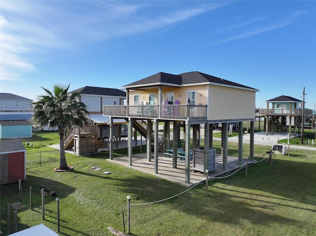 back of property with a patio area, a yard, and a wooden deck