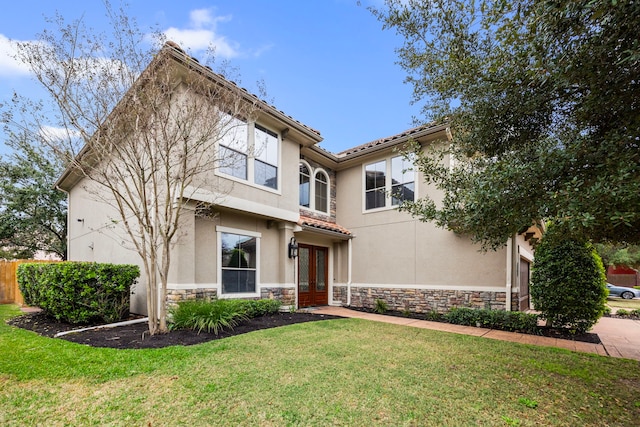 view of front facade with a front yard and french doors