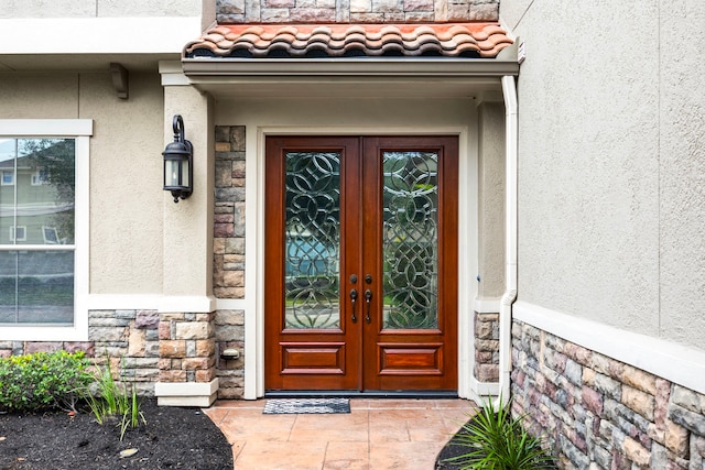 property entrance featuring french doors