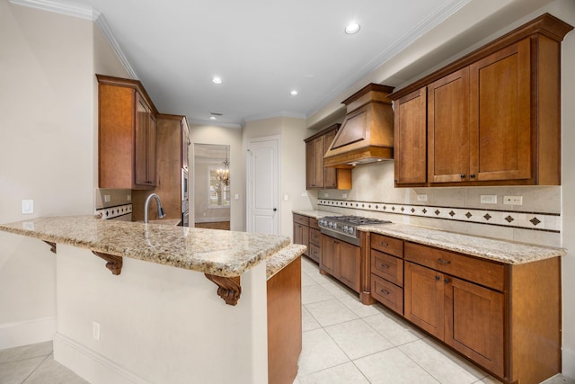 kitchen with a kitchen bar, decorative backsplash, kitchen peninsula, premium range hood, and stainless steel gas cooktop