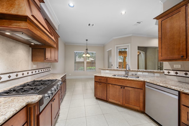 kitchen with hanging light fixtures, crown molding, sink, appliances with stainless steel finishes, and light stone counters