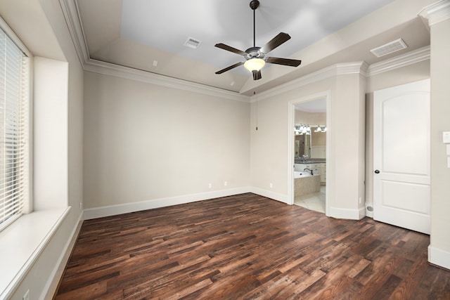 unfurnished room featuring a raised ceiling, ceiling fan, crown molding, and dark hardwood / wood-style floors