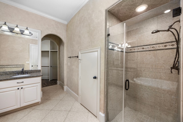 bathroom featuring tile patterned floors, vanity, an enclosed shower, and ornamental molding