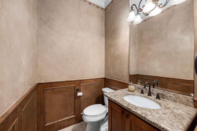 bathroom featuring tile patterned floors, vanity, ornamental molding, and toilet