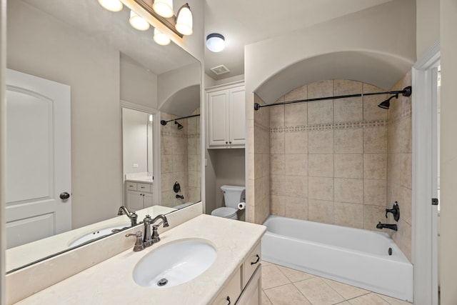 full bathroom with tile patterned flooring, vanity, toilet, and tiled shower / bath combo