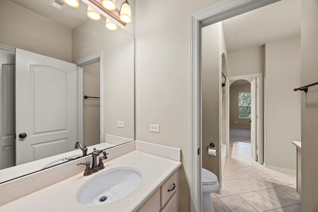 bathroom featuring tile patterned flooring, vanity, and toilet