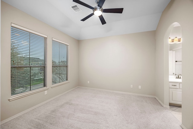 spare room with light colored carpet, ceiling fan, lofted ceiling, and sink