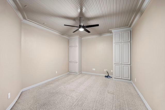 carpeted spare room featuring ceiling fan and ornamental molding