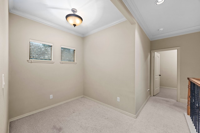 carpeted empty room featuring crown molding