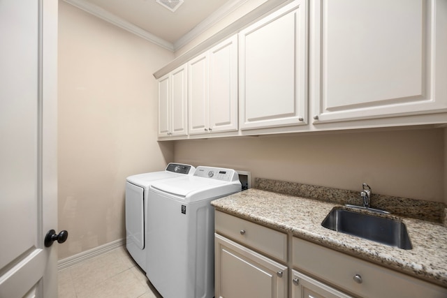 clothes washing area featuring cabinets, sink, separate washer and dryer, light tile patterned floors, and ornamental molding