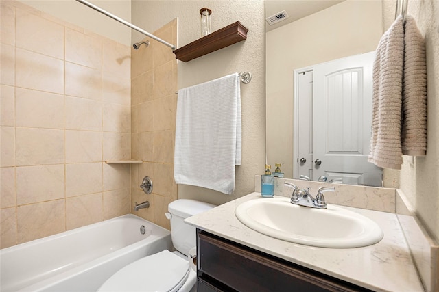 full bathroom with toilet, tiled shower / bath combo, and vanity