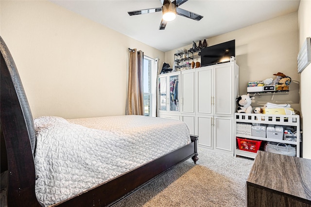 bedroom with ceiling fan and light colored carpet