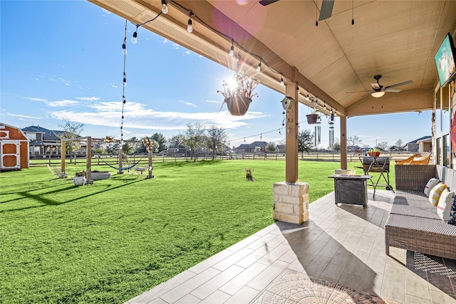 view of yard featuring an outdoor living space, ceiling fan, and a patio