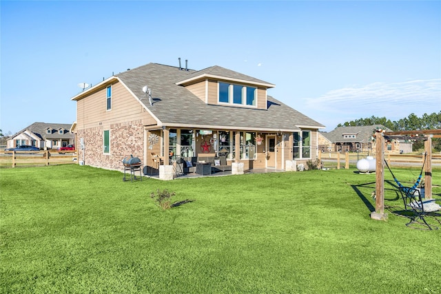 rear view of property with a patio area and a lawn