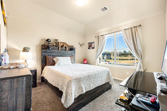 carpeted bedroom with vaulted ceiling