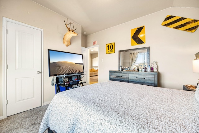 bedroom featuring vaulted ceiling and carpet flooring