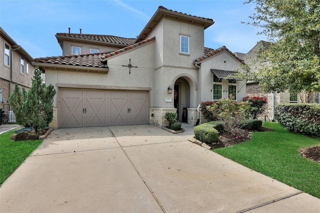 mediterranean / spanish house with a front yard and a garage