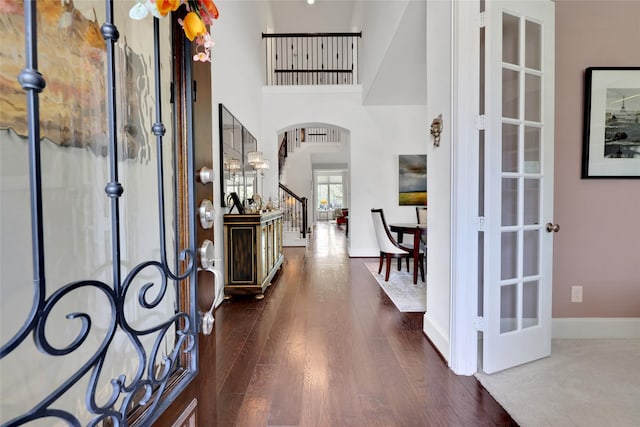 foyer entrance with french doors and dark hardwood / wood-style flooring