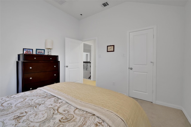 bedroom with light carpet and vaulted ceiling