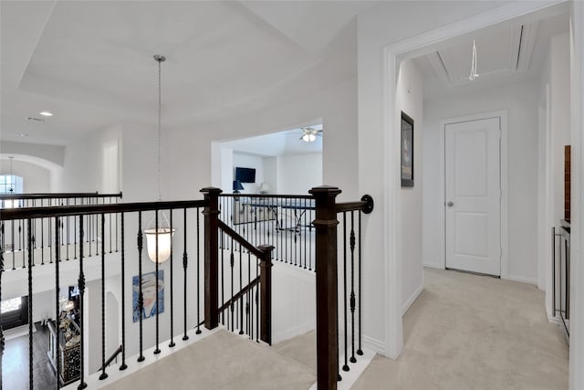 corridor featuring light colored carpet