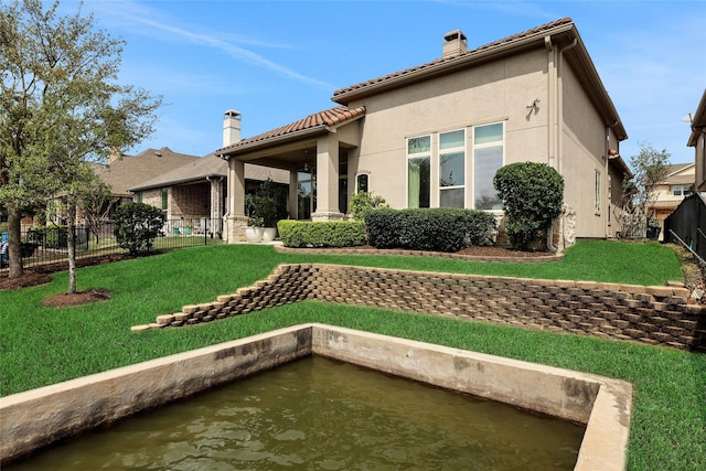 rear view of property with a lawn